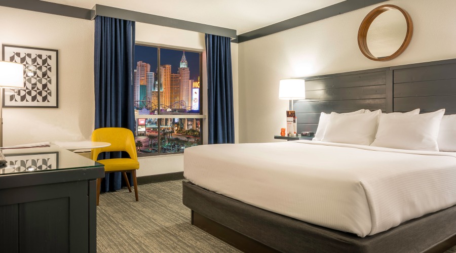 One king bed next to window with Strip view